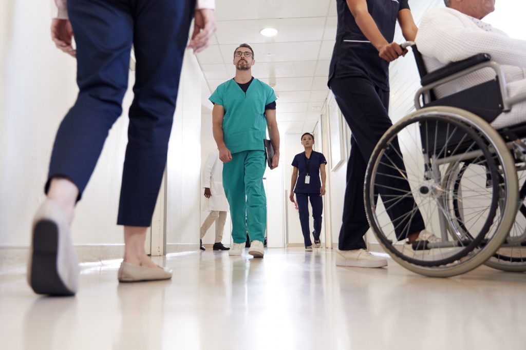 Busy Hospital Corridor With Medical Staff And Patients